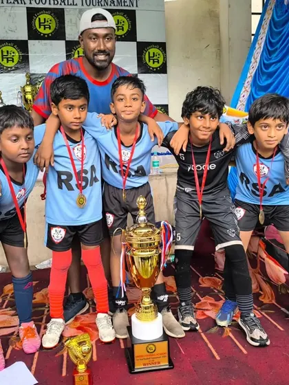 The victorious U10 team with their coach after being crowned champions at the United Football Academy tournament.