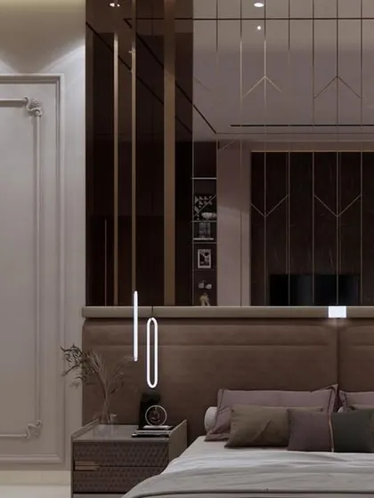 A close-up of the bed and headboard, showcasing the use of tinted mirrors and classical mouldings. The design is a perfect example of how we combine different styles to create a unique and luxurious space.
