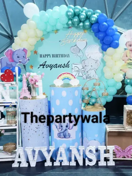 A sweet baby elephant theme for a first birthday. The light blue decor is accented with cute elephant cutouts and a 'ONE' shelf.