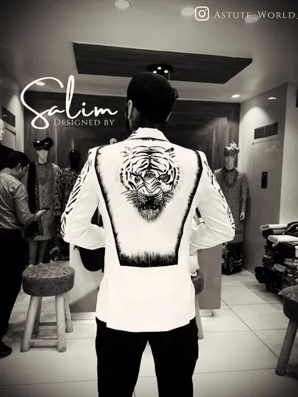 A custom white blazer with a hand-painted tiger design on the back. The black and white artwork creates a striking contrast, perfect for making a memorable entrance.