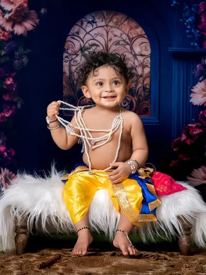 Little Krishna, big blessings. This elaborate floral backdrop creates a truly magical setting for our Krishna theme.