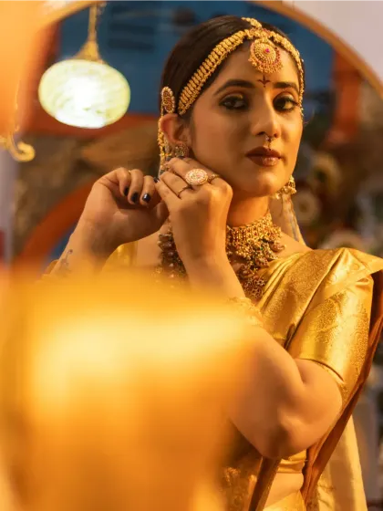 An artistic shot of the bride looking into a mirror, perfect for a wedding album.
