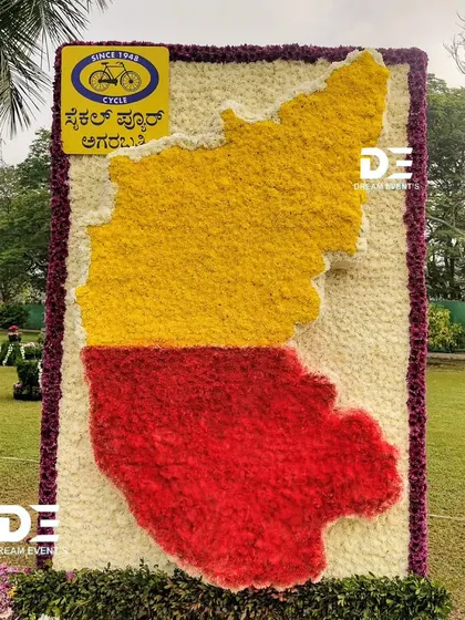 I created this large-scale map of Karnataka using our state's iconic red and yellow colors, crafted entirely from fresh flowers. This piece was a celebration of regional pride and a demonstration of intricate floral design on a massive scale.