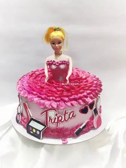 A classic Barbie doll cake with a beautiful pink dress piped from buttercream. The design also includes edible makeup-themed accents for a touch of glamour.