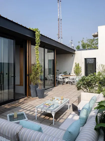 A workplace should also provide moments of respite. This lush terrace garden at a Delhi office serves as a green oasis for employees and a space for social gatherings, reflecting our commitment to designing human-centric environments.