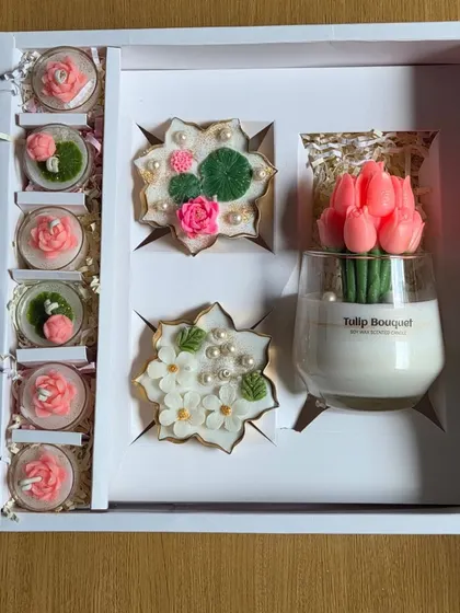 Another view of the large corporate gift box, showing the beautiful arrangement of the tulip candle, urli candles, and smaller floral candles.