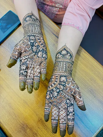 This set shows a popular style with a central personalized element, surrounded by floral and geometric patterns that extend up the arm.