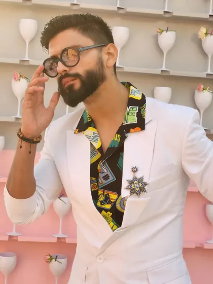 A quirky and stylish white suit paired with a printed shirt. This look is perfect for a fun, themed party or a creative brand event.