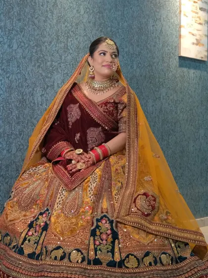 Another angle of this gorgeous multi-colored bridal lehenga. The heavy embroidery on the skirt pairs beautifully with the traditional choker and earring set, which you can rent together.