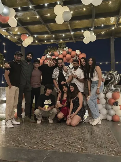 A happy group poses for a photo in front of the birthday backdrop. My rooftop provides the perfect setting for capturing memories with your favorite people.
