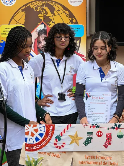 Students at a booth during the Christmas Mela. This image showcases the festive spirit and student involvement that characterize our seasonal events.