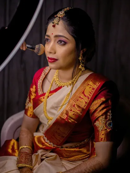 Another angle of this Brahmin bride, showing the makeup application in progress with a ring light to ensure perfection.