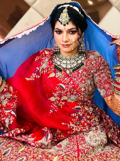 The bride revealing her full look from under the dupatta. This is always a magical moment, and the makeup is designed to be breathtaking.