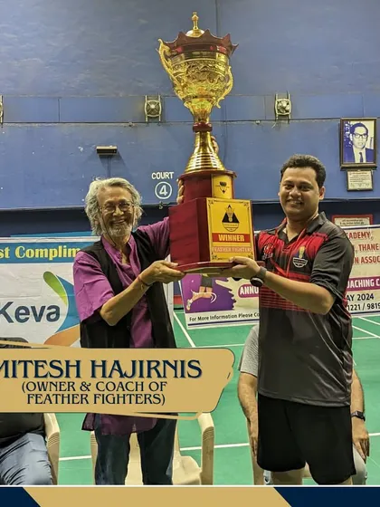 A moment of triumph for Mitesh Hajirnis, owner of the winning team Feather Fighters, as he lifts the championship trophy.