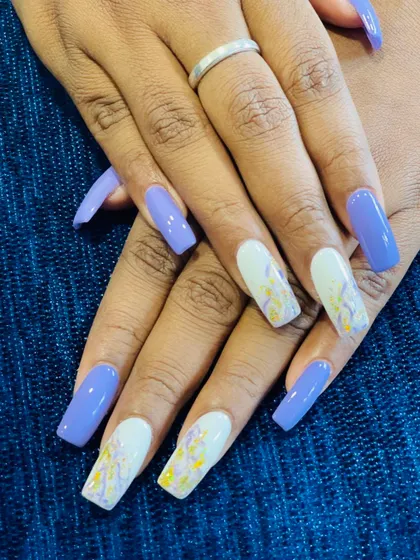 We love this combination of solid lavender purple and abstract watercolor accent nails. The hints of yellow and white on the accent nails create a beautiful, artistic contrast.