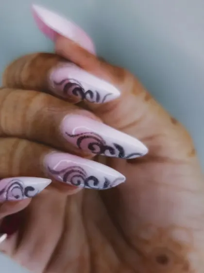 A side view of the edgy stiletto nails, showing the sharp shape.