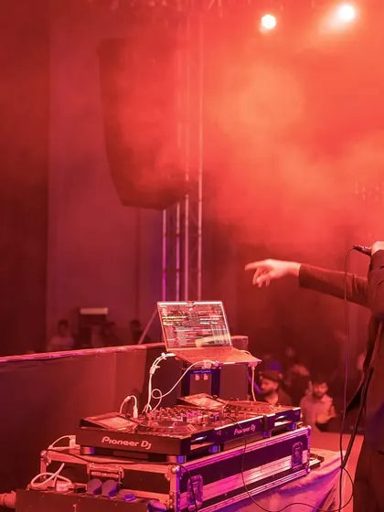 Setting the mood with red lighting and a high-energy set for the corporate crowd.