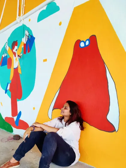 Taking a moment to rest and reflect beside a colorful, abstract mural. Every canvas is a journey, and we pour our emotions and stories into each one.