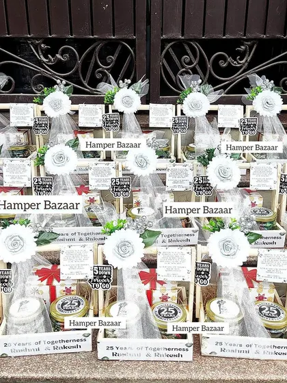 A whole array of our Silver Jubilee hampers, ready for the celebration. Each one includes a customized mug and jars of truffle chocolates and paan kishmish.