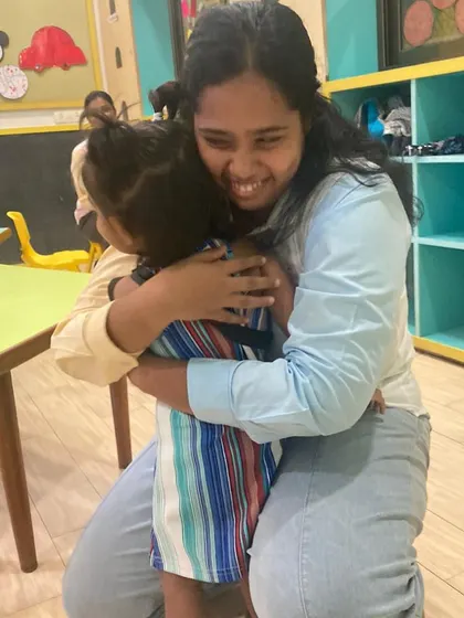A hug between a trainer and a child says it all. We believe in connection before cognition, and this photo captures the warm, nurturing relationships that are at the heart of our program.