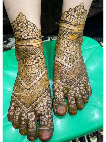 A full view of a traditional Pakistani bridal foot design, known for its density and intricate detail.