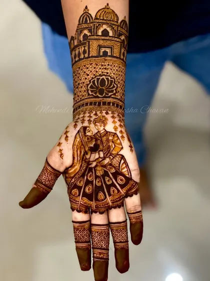 A close-up of a bridal figure work, showing a couple portrait and a Taj Mahal design. The detail and artistry make it a stunning piece.