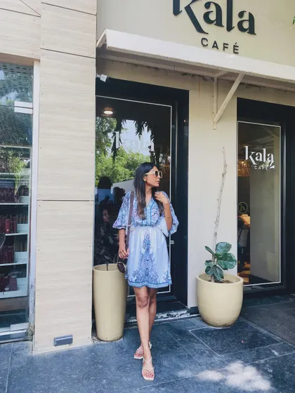 A blue and white printed dress that's perfect for a lunch date in Delhi. Paired with simple flats and sunglasses, it's a complete and easy-going look.
