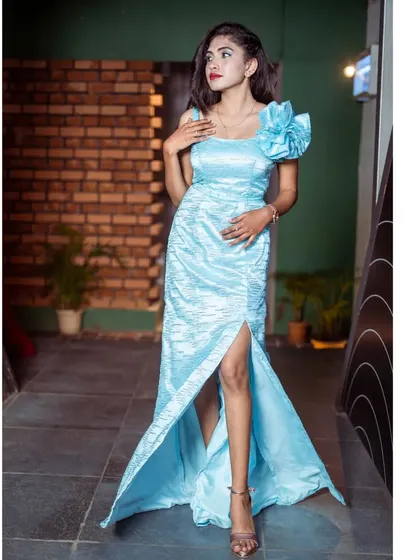 Another pose in the light blue satin gown, showing its elegant design.