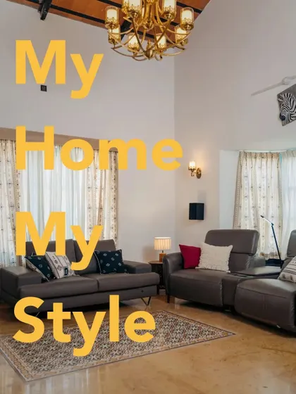 The full view of Arpit's stylish living room. The high ceilings and grand archway are beautifully complemented by the long, flowing drapes, making the space feel both grand and grounded.