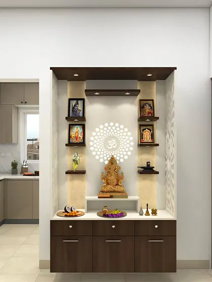 This pooja unit is elegantly integrated into an alcove, featuring a Ganesha idol as the centerpiece. The design includes floating shelves for pictures and drawers for storage, with spotlights to highlight the sacred space.