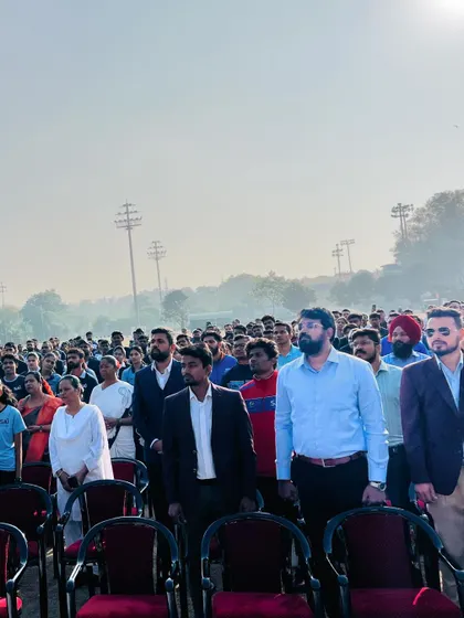 A view of the audience, a mix of athletes, coaches, and staff, all standing in respect for the national anthem. The unity on display is inspiring.