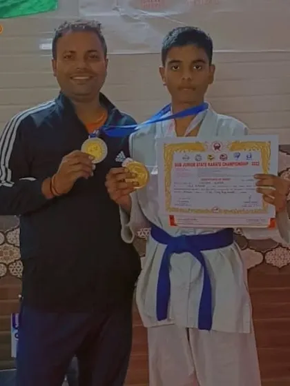 A proud coach with his student Shiva, who won gold at the sub-junior state karate championship.