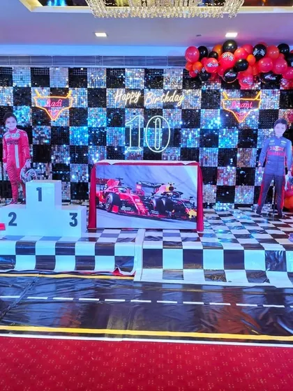 This Formula 1 racing theme was a huge hit, featuring a checkered sequin backdrop, a winner's podium, and custom cutouts. I love bringing high energy themes like this to life for birthdays.