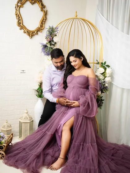 The couple shares a quiet moment together in our floral setup. This pose highlights their connection and the beautiful silhouette of the baby bump.