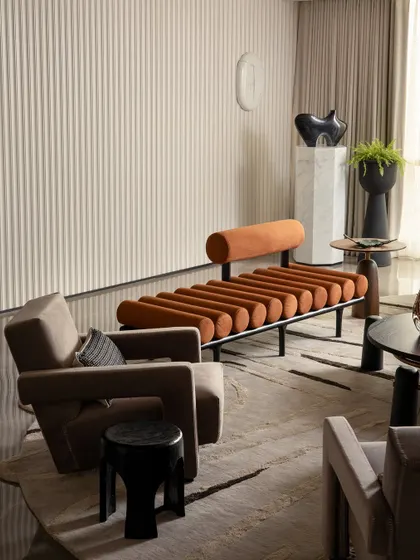 This living area from a Parisian-inspired home showcases my passion for curating unique pieces. The space combines a fluted feature wall, sculptural furniture, and contemporary art to create a layered and eclectic look that is both artistic and comfortable.