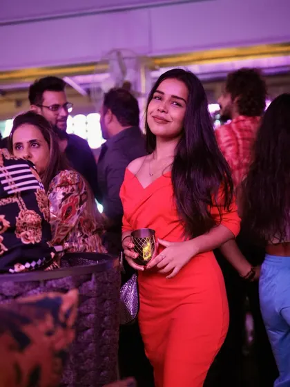 A guest in a vibrant red dress, adding a pop of color to the night.