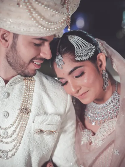 A tender close-up of the couple, with the bride resting her head on the groom's shoulder.