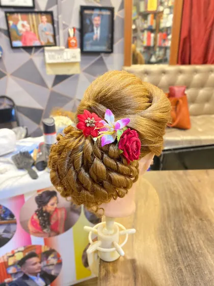 The same student-made hairstyle from a slightly different angle, showing the volume and structure of the updo.