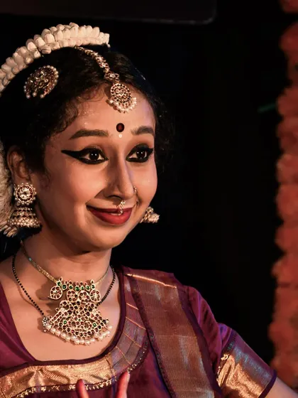 The radiant smile of the performer, sharing the joy of dance with the audience.
