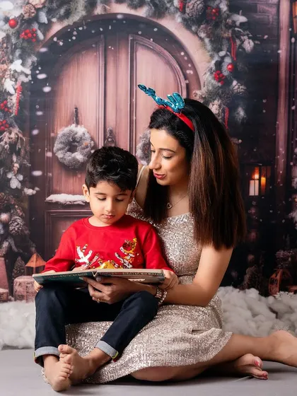Reading a Christmas story in a magical, snowy setting. These themed setups transport families to a winter wonderland, right in my Mumbai studio.
