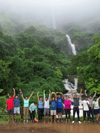 The group making a "YMCA" pose in front of a waterfall. We always find ways to have fun.