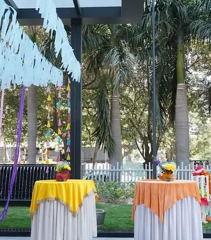 Colorful table setups for an outdoor Mehendi. Using different colored tablecloths adds to the festive, carnival-like atmosphere of the celebration.