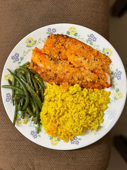 A delicious meal of turmeric rice with air-fried salmon and a side of sautéed green beans.