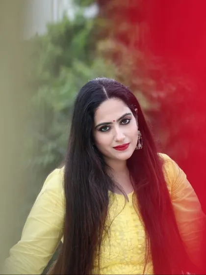 A simple and elegant portrait of a model in a yellow kurti. The creative use of a red color gel adds an artistic flair to the shot.