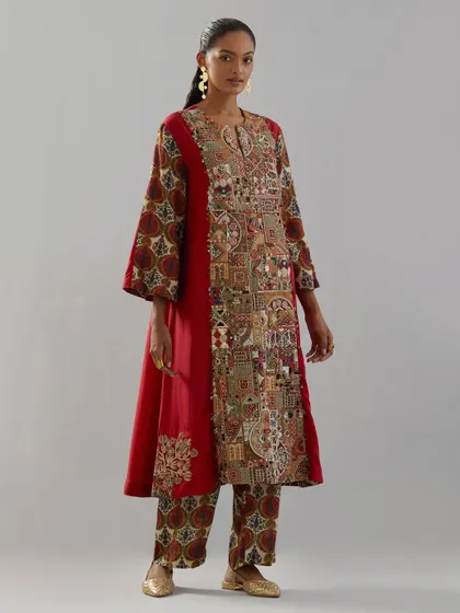 A striking red kurta with a panel of intricate, multi-colored embroidery depicting a traditional scene. This is a perfect example of how clothing can tell a story.