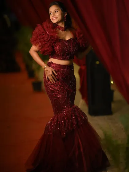 Anusha looking glamorous and confident in her custom red gown.