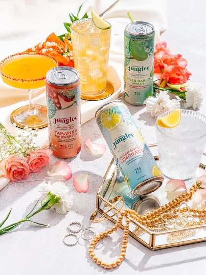 A bright and feminine styling for a canned cocktail brand, using flowers and jewelry as props.