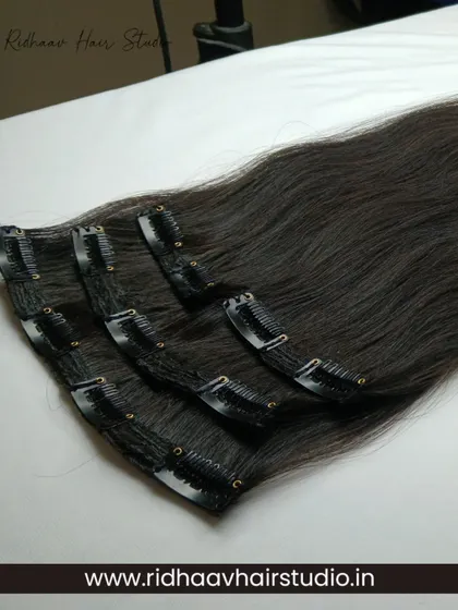 The 4-piece straight clip-in set laid out to show the different wefts. This versatile set allows you to add volume and length exactly where you need it for a customized look.