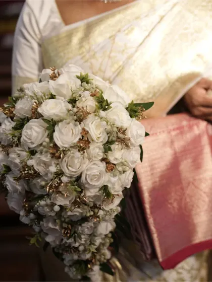 A close-up of the bride's stunning cascading bouquet of white roses. This is a perfect example of how I ensure every single detail, no matter how small, is crafted to perfection for the big day.