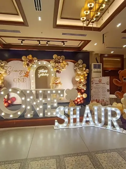 We made Shaurya's first birthday extra special with these giant marquee letters spelling out his name. The teddy bear theme, complete with a lighted "ONE" sign and a beautiful balloon backdrop, created a grand and adorable stage for the celebration.